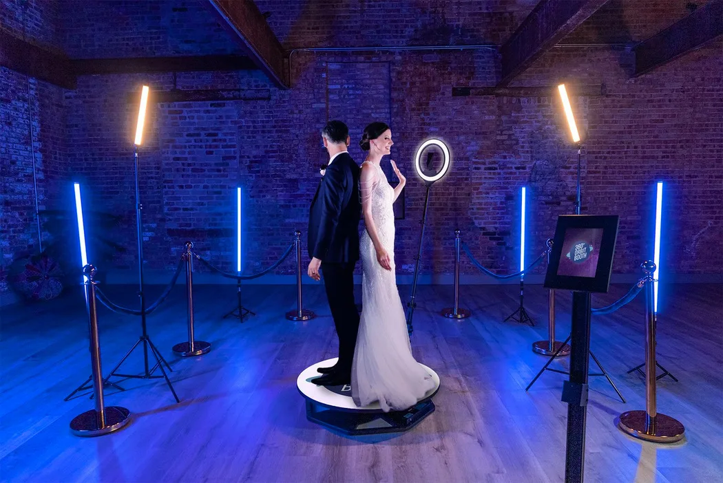 A bride and groom on the 360° video booth platform